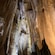 Large stalactites hanging from the ceiling of a cave